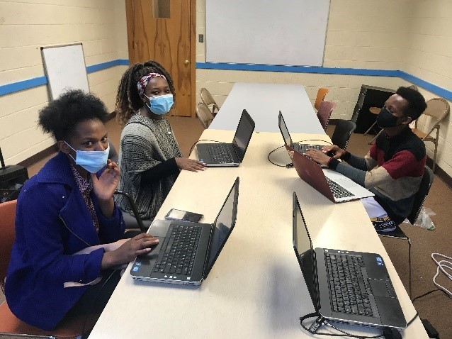 Three high school students at a study center supervised by the African Resource Center